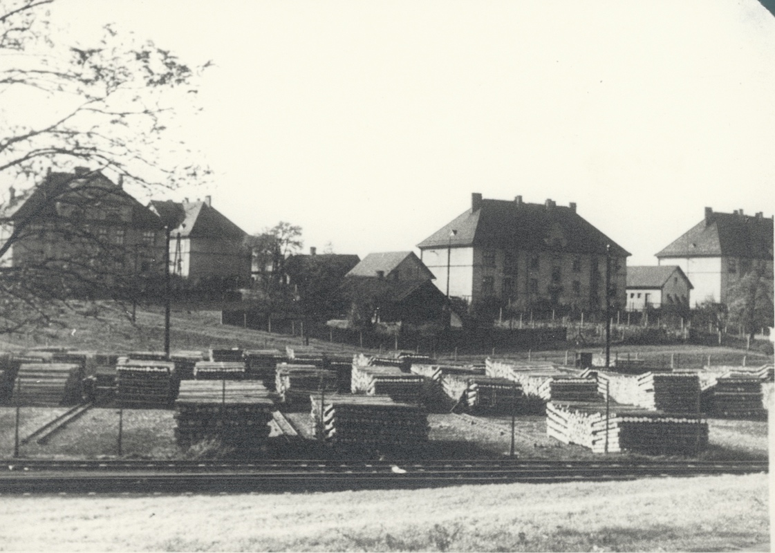 V popředí překladiště dřeva. V pozadí zleva dům čp. 1605 (za ním část domu čp. 1604), následuje dům čp. 1640 a úplně vpravo část domu čp. 1651.