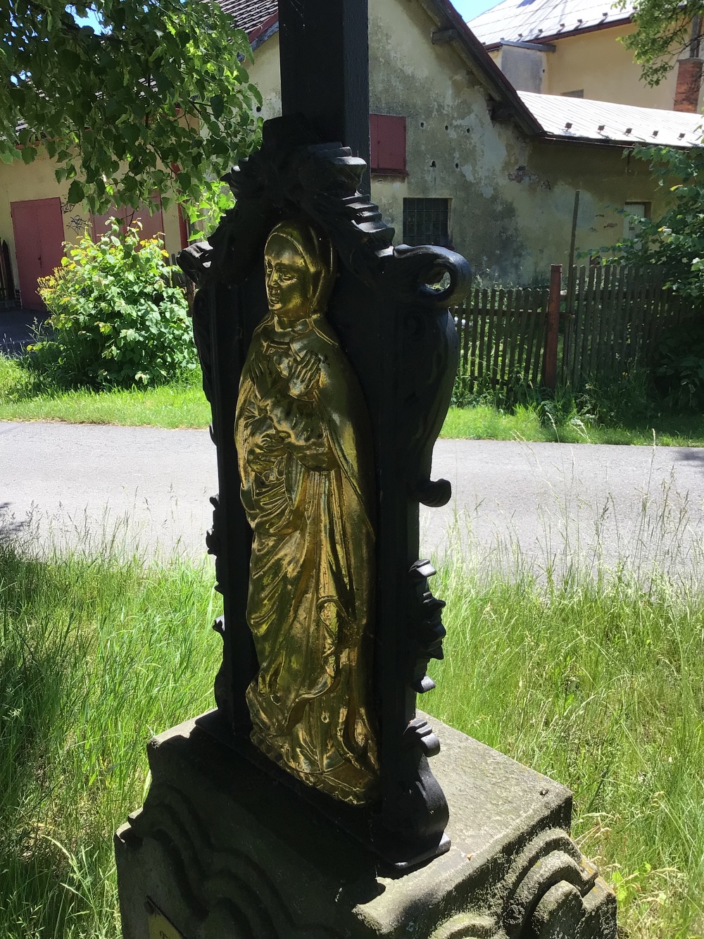 Litinový kříž s korpusem Krista a reliéfem Bolestné Panny Marie, osazený na kamenném soklu, pravděpodobně z 2. poloviny 19. století (Dolní Marklovice). KULTURNÍ PAMÁTKA