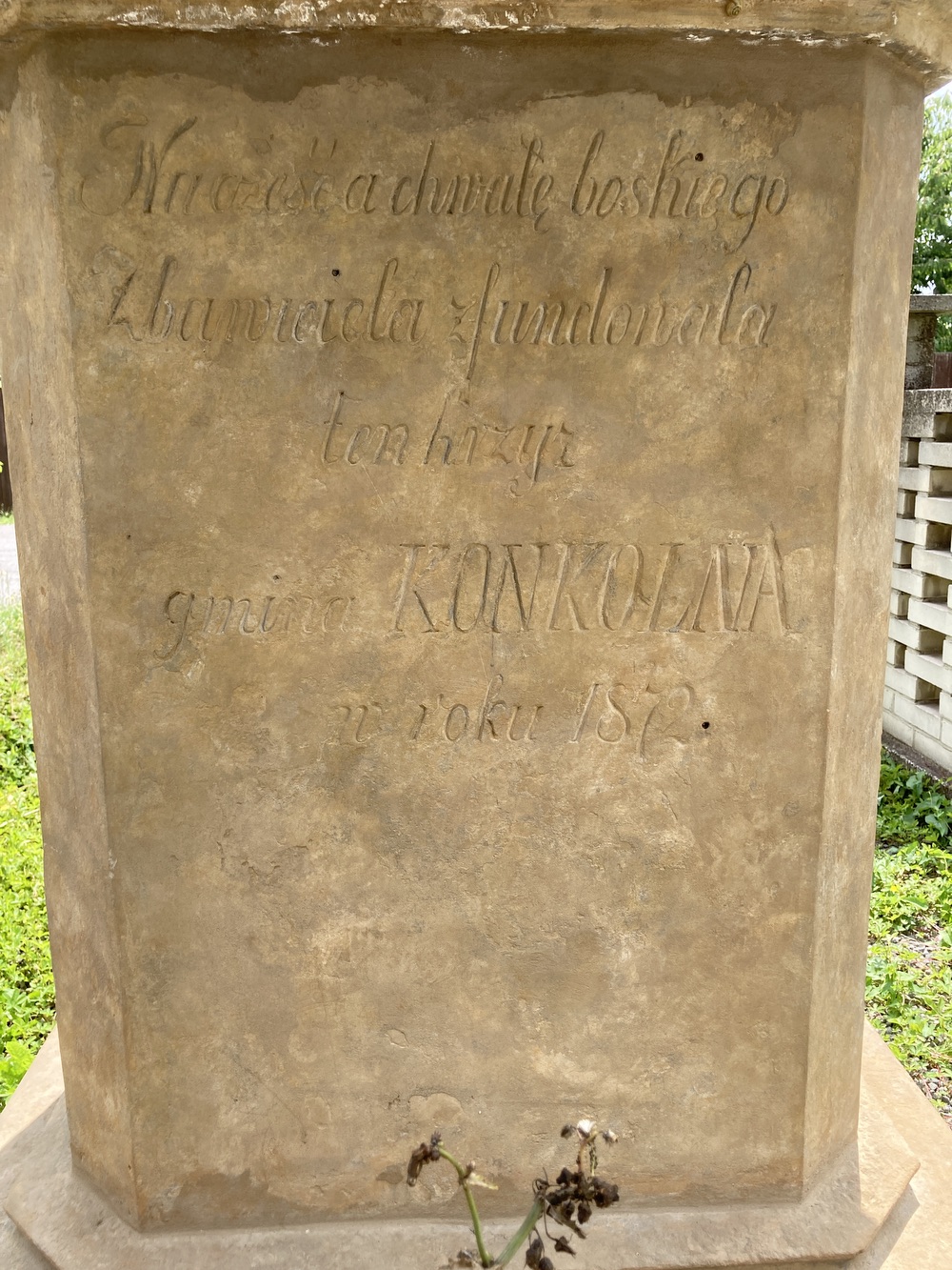 Kamenný kříž z roku 1872 u domu čp. 9 v Koukolné (text: Na cześć a chwale boskiego Zbawiciela zfundowala ten krzyz gmina KONKOLNA w roku 1872)