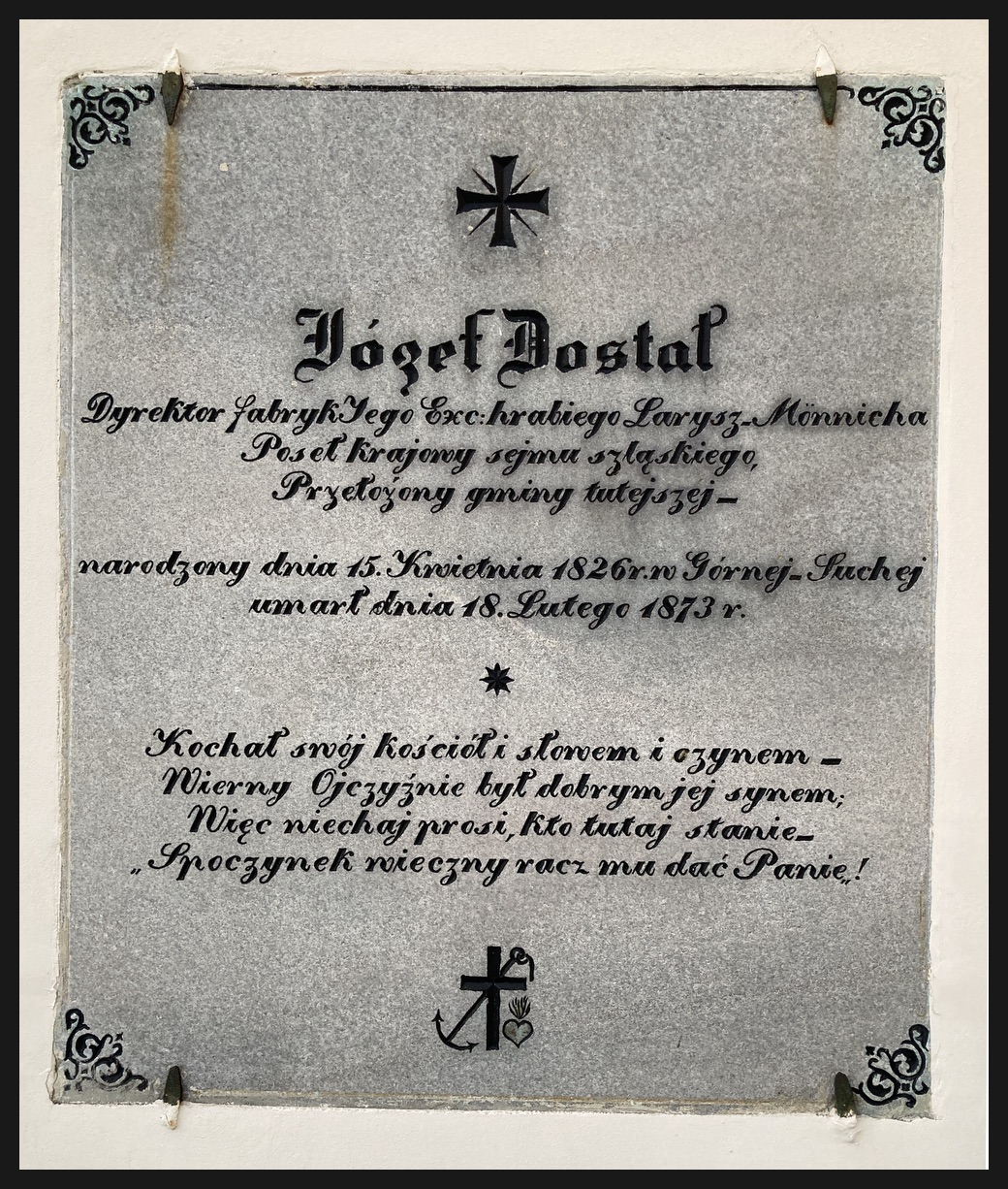 Pamětní deska Józefa Dostala, prvního starosty obce Horní Suchá v letech 1864-1873, umístěná na kostele sv. Josefa v Horní Suché.