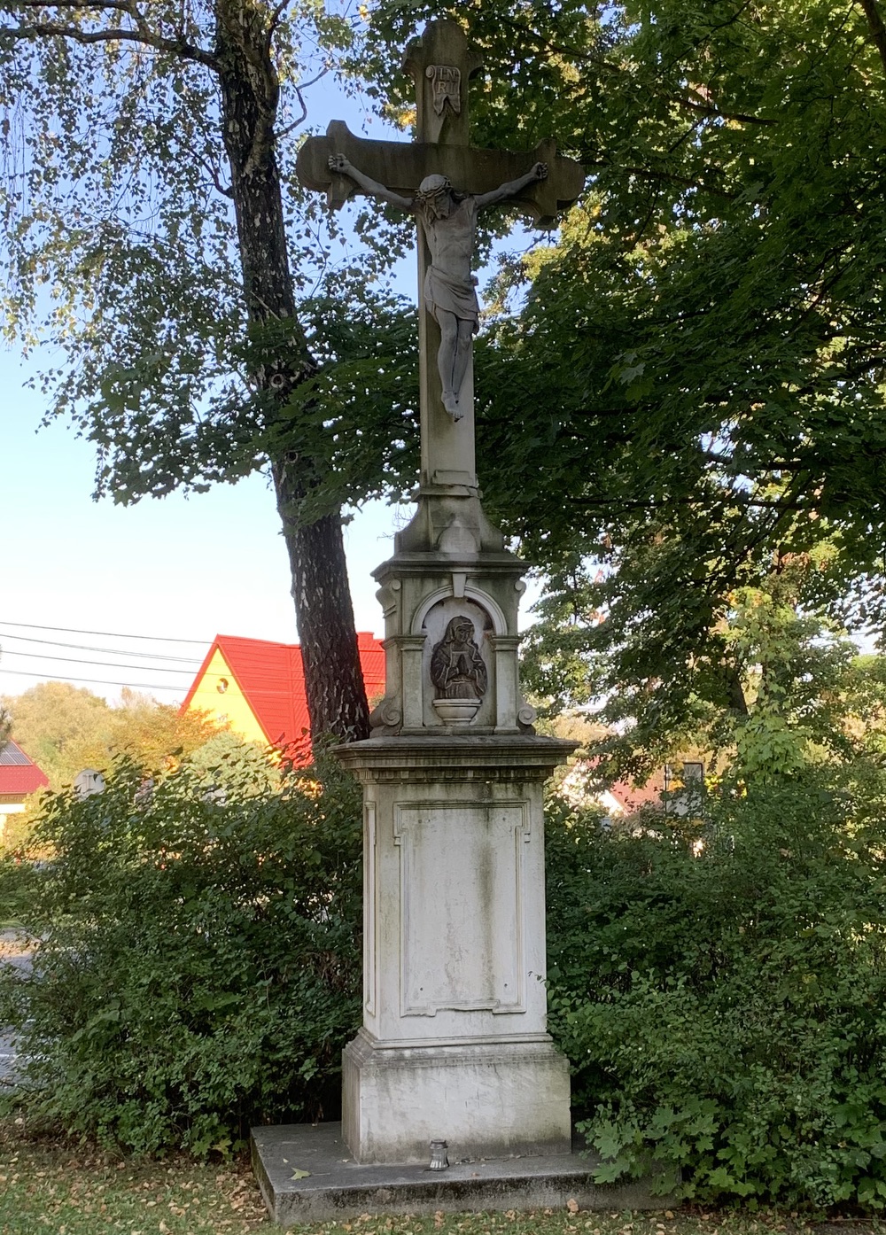 Kamenný kříž z roku 1894 u kostela sv. Petra a Pavla v Albrechticích. Kříž původně stával u kostela sv. Jindřicha ve staré Karvinné. (Fotografováno: 26.9.2023. Autor: Szarowská Olga)